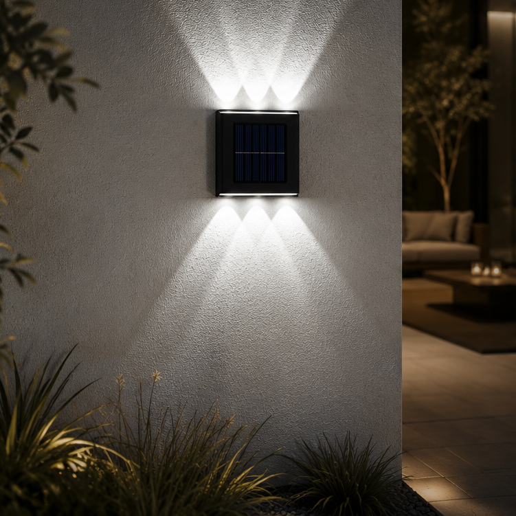 Solar wall light fixture on a textured outdoor wall with plants and a building interior in the background.